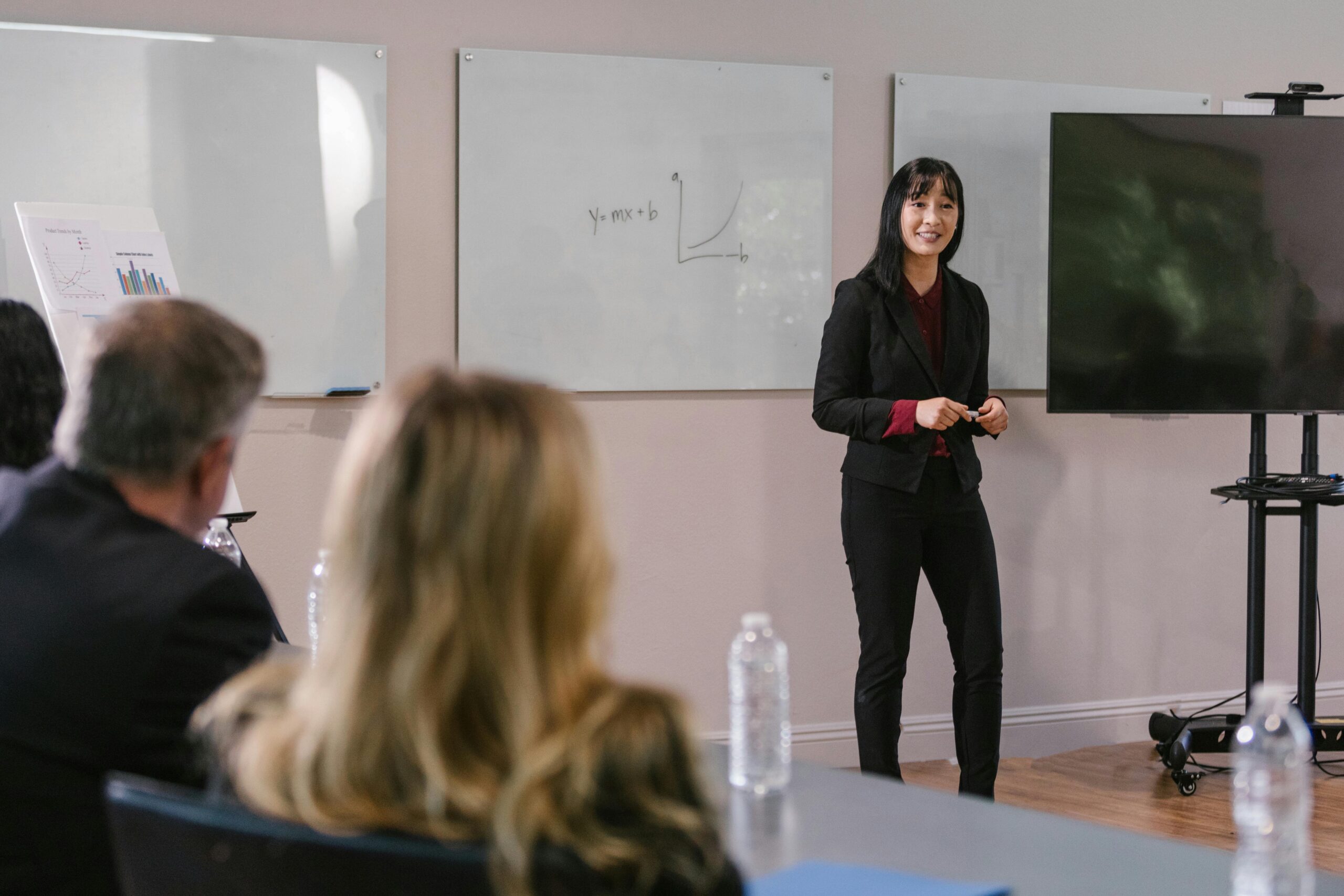 new leader presenting to a group of senior executives